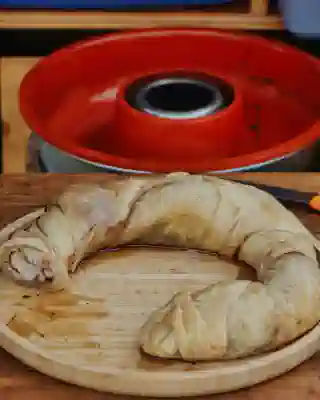 The cinnamon roll is on a plate and sliced. In the background, you can see the Omnia oven.