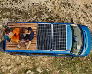 A top view of the Quest. Two solar panels are visible, and on the wooden top are Jo and Georg.