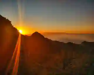 First view of Tenerife. The sun sets behind the mountains