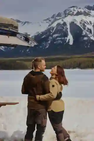 Jo and Georg by a frozen lake with a mountain in the background.