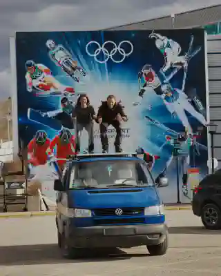 In front of the Olympic Center. Jo and Georg on the roof of the Quest in ski jump position.