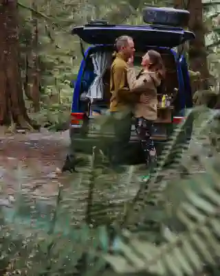 The Quest in the Rainforest. Georg and Jo stand in front of the open tailgate.