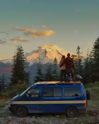 Our Van in front of the Mt Baker with Jo and Georg on the roof.